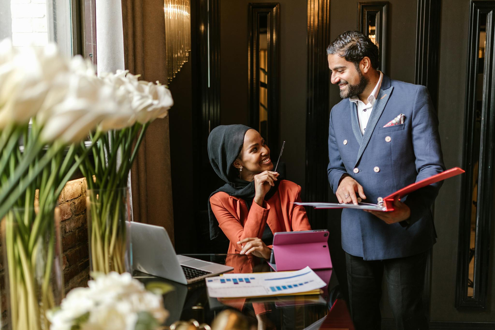 A friendly business meeting with a smiling team in an elegant office setting.
